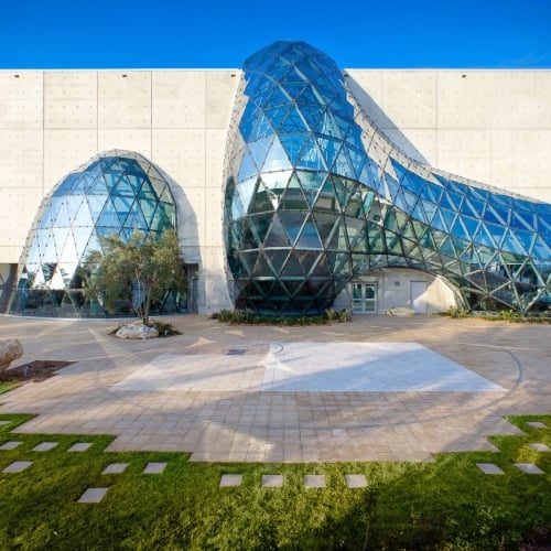 Modern architecture of The Dalí Museum featuring a fluid, geodesic glass bubble built into concrete.